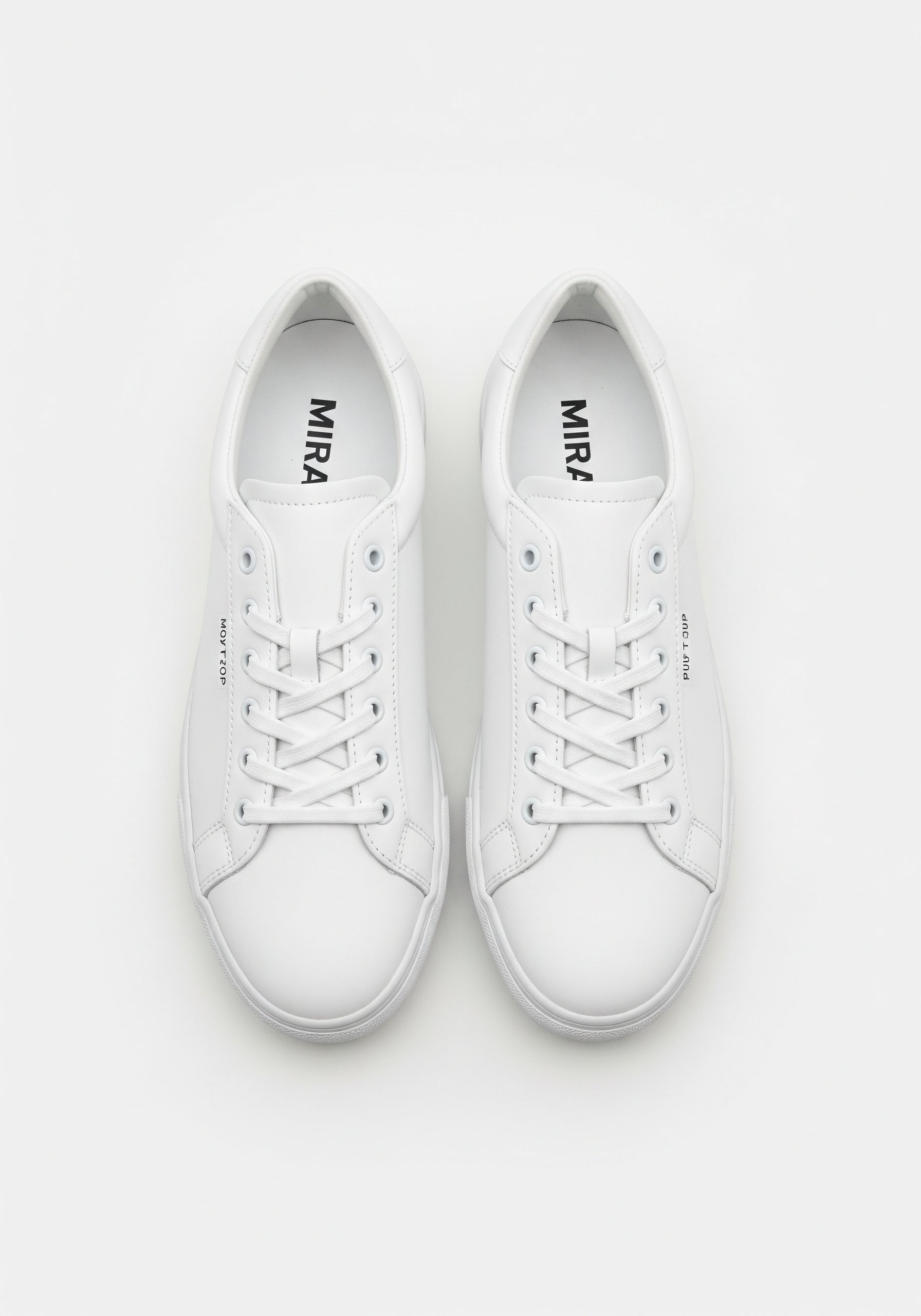 Pair of white sneakers with 'MIRA' branding on a light gray background